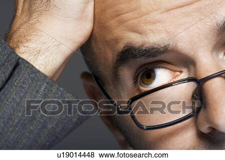 Balding businessman wearing glasses, hand on head, close up View Large Photo Image Stock Photo - Balding businessman wearing glasses, hand on head, close up. Fotosearch