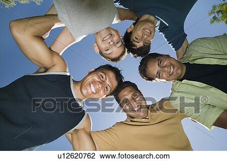 Boy (13-15) with brothers and father in huddle, view from below. View Large Photo Image Stock Image - Boy (13-15) with brothers and father in huddle, view from below.. Fotosearch