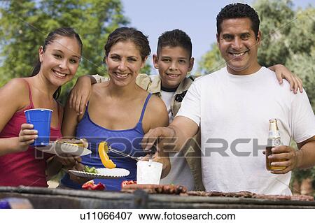 Boy (13-15) with family at outdoor grill, front view. View Large Photo Image Stock Photo - Boy (13-15) with family at outdoor grill, front view.. Fotosearch