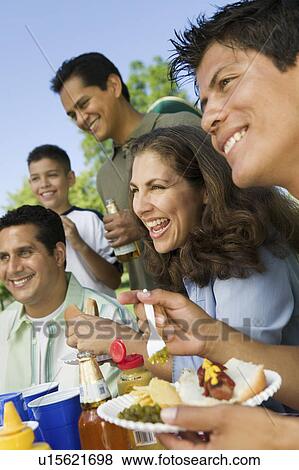 Boy (13-15) with family at outdoor picnic. View Large Photo Image Stock Photo - Boy (13-15) with family at outdoor picnic.. Fotosearch