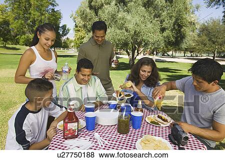Boy (13-15) with family at picnic. View Large Photo Image Stock Photo - Boy (13-15) with family at picnic.. Fotosearch