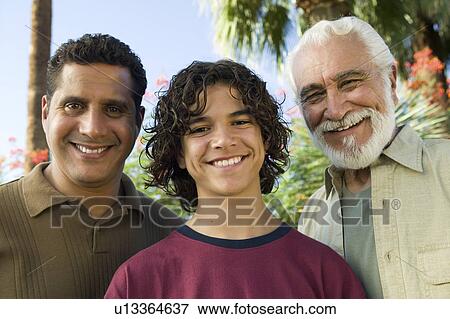 Stock Photo - Boy (13-15) with Father and Grandfather outdoors, front view portrait.. Fotosearch