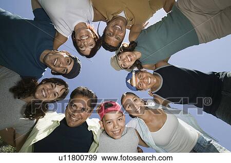 Boy (13-15) with friends and family in huddle, view from below. View Large Photo Image Stock Photo - Boy (13-15) with friends and family in huddle, view from below.. Fotosearch