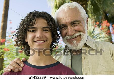 Picture - Boy (13-15) with Grandfather outdoors, front view portrait.. Fotosearch