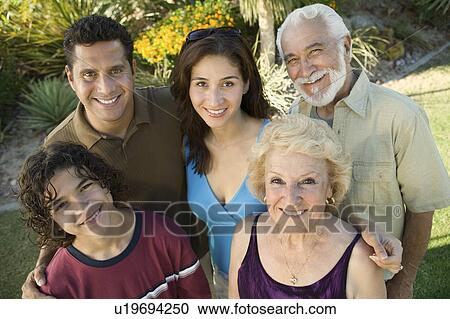Stock Image - Boy (13-15) with parents and grandparents, outside, elevated view portrait.. Fotosearch
