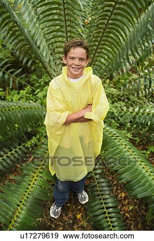 Stock Photo - Boy Standing by Fern. Fotosearch