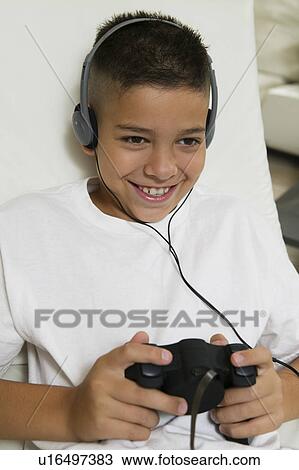 Boy with Headphones Playing Video Game View Large Photo Image Stock Image - Boy with Headphones Playing Video Game. Fotosearch