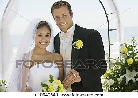 Bride and Groom under archway, outdoors, (portrait) View Large Photo Image Stock Image - Bride and Groom under archway, outdoors, (portrait). Fotosearch