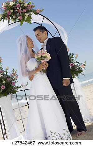 Bride and Groom under archway View Large Photo Image Stock Photo - Bride and Groom under archway. Fotosearch