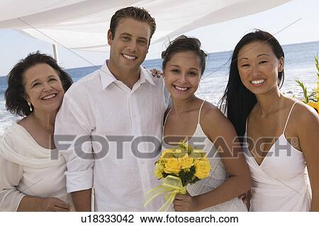 Bride and groom with family at beach wedding, (portrait) View Large Photo Image Stock Image - Bride and groom with family at beach wedding, (portrait). Fotosearch