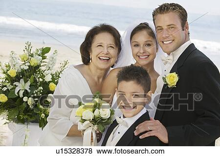 Stock Photo - Bride and Groom with mother and brother, outdoors, (portrait). Fotosearch