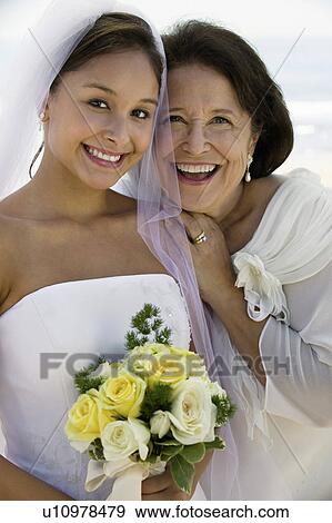 Stock Photo - Bride and mother with flowers, smiling, (close-up), (portrait). Fotosearch