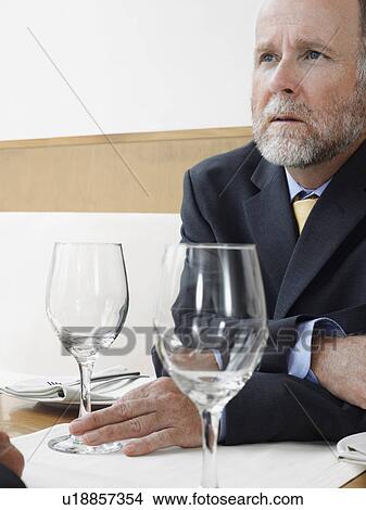 Picture - Businessman in restaurant. Fotosearch