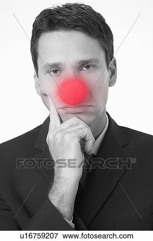 Businessman with head in hands, wearing Clown Nose, portrait View Large Photo Image Stock Photo - Businessman with head in hands, wearing Clown Nose, portrait. Fotosearch