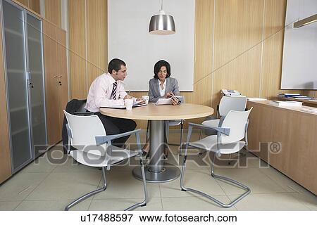 Businesspeople having meeting in office View Large Photo Image Stock Photo - Businesspeople having meeting in office. Fotosearch