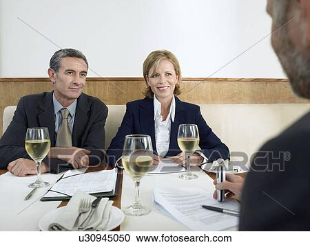 Businesspeople having meeting in restaurant View Large Photo Image Stock Image - Businesspeople having meeting in restaurant. Fotosearch