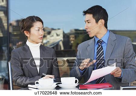 Businesspeople Meeting at outdoor Cafe, reviewing documents View Large Photo Image Stock Photo - Businesspeople Meeting at outdoor Cafe, reviewing documents. Fotosearch