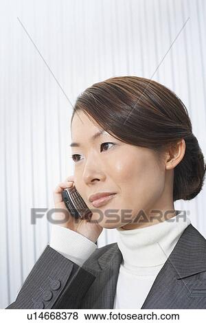 Stock Photo - Businesswoman using Cell Phone. Fotosearch