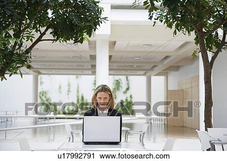 Businesswoman using laptop, outdoors View Large Photo Image Stock Image - Businesswoman using laptop, outdoors. Fotosearch
