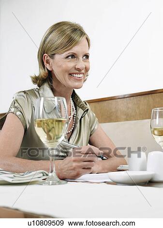 Stock Photo - Businesswoman working in restaurant. Fotosearch