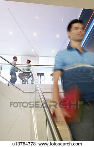 Casually dressed Businessman Walking down Stairs View Large Photo Image Stock Photo - Casually dressed Businessman Walking down Stairs. Fotosearch