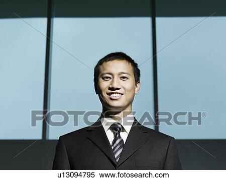 Confident Businessman, low angle view View Large Photo Image Stock Photography - Confident Businessman, low angle view. Fotosearch
