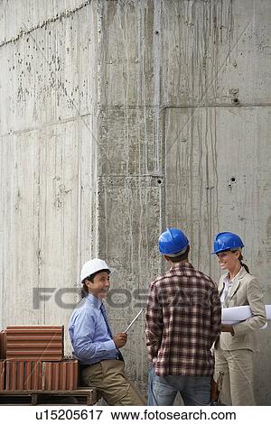 Construction team talking on site View Large Photo Image Stock Photo - Construction team talking on site. Fotosearch
