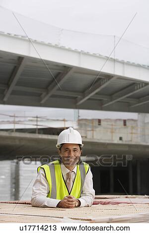 Stock Image - Construction worker at building site. Fotosearch