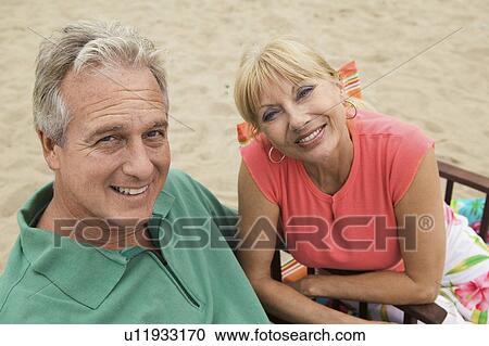 Stock Image - Couple at beach, (portrait). Fotosearch