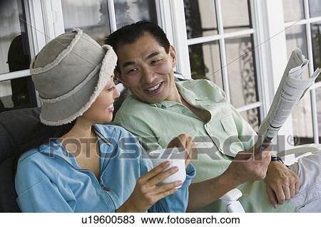 Couple drinking coffee and reading newspaper on porch View Large Photo Image Stock Image - Couple drinking coffee and reading newspaper on porch. Fotosearch
