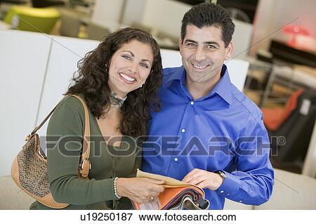 Couple in store looking at Fabric Swatches, portrait View Large Photo Image Stock Photo - Couple in store looking at Fabric Swatches, portrait. Fotosearch