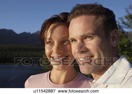 Stock Photo - Couple outdoors by lake.. Fotosearch