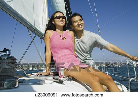 Stock Image - Couple sailing. Fotosearch