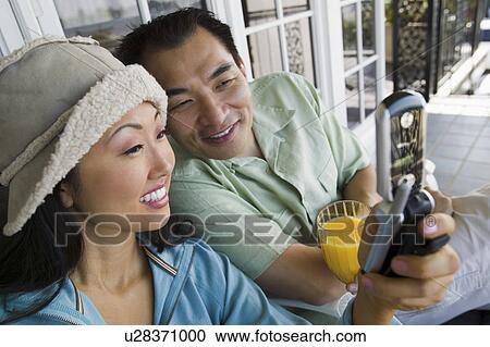 Couple using mobile phone on porch View Large Photo Image Stock Image - Couple using mobile phone on porch. Fotosearch