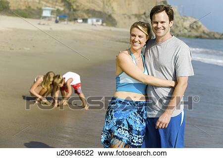 Couple with Family Enjoying Beach View Large Photo Image Stock Image - Couple with Family Enjoying Beach. Fotosearch