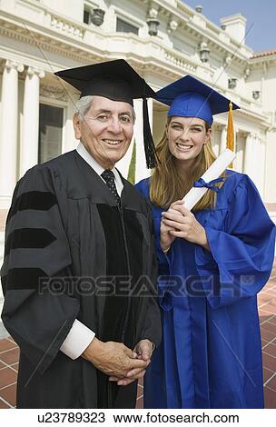 Stock Image - Dean and graduate outside university, portrait. Fotosearch