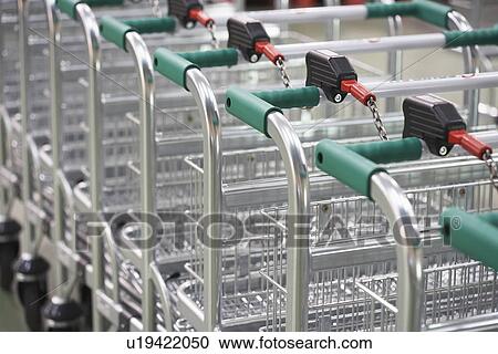 Empty Shopping Carts linked together View Large Photo Image Stock Image - Empty Shopping Carts linked together. Fotosearch