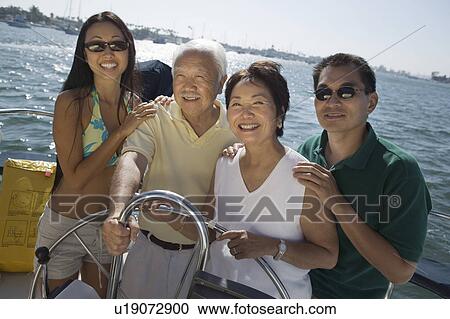 Stock Image - Family on boat, (portrait). Fotosearch