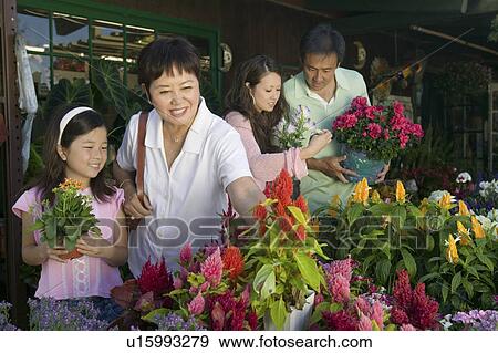 Stock Photo - Family Shopping for Plants in nursery. Fotosearch