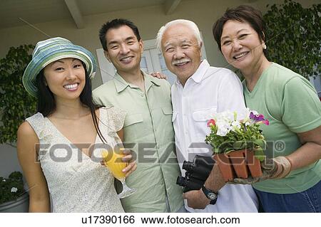 Stock Photograph - Family smiling outdoors, (portrait). Fotosearch