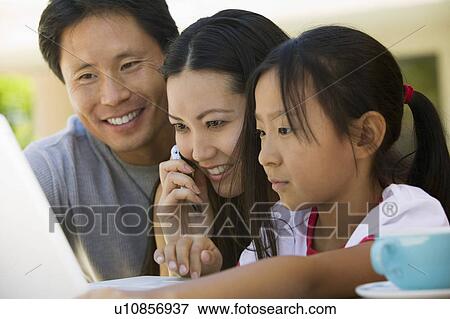 Family Using Laptop in backyard, close up View Large Photo Image Stock Photo - Family Using Laptop in backyard, close up. Fotosearch