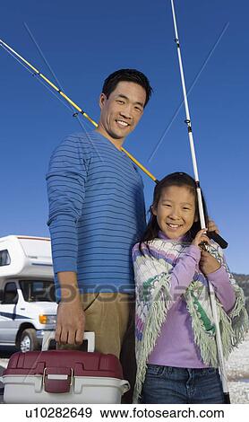 Father and daughter holding fishing poles outside RV View Large Photo Image Stock Photo - Father and daughter holding fishing poles outside RV. Fotosearch