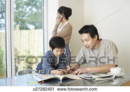 Father and Son coloring in Coloring Book on table, mother talking on mobile View Large Photo Image Stock Image - Father and Son coloring in Coloring Book on table, mother talking on mobile. Fotosearch