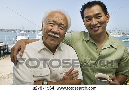 Father and son embracing, outdoors, (portrait) View Large Photo Image Picture - Father and son embracing, outdoors, (portrait). Fotosearch
