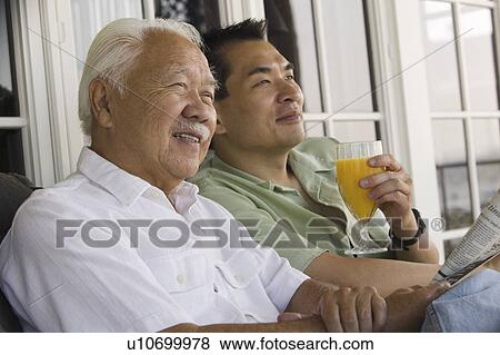 Father and son relaxing outside home View Large Photo Image Stock Photo - Father and son relaxing outside home. Fotosearch