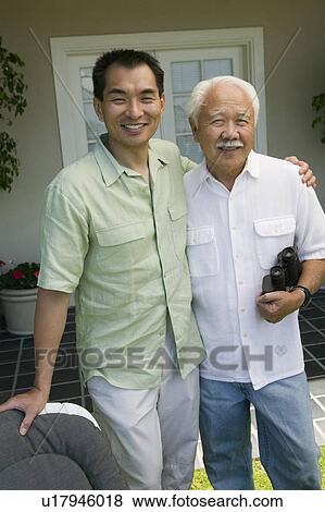Father and son with binoculars, outdoors, (portrait) View Large Photo Image Stock Photo - Father and son with binoculars, outdoors, (portrait). Fotosearch