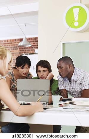Four people having meeting around laptop. View Large Photo Image Stock Image - Four people having meeting around laptop.. Fotosearch