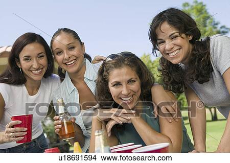 Picture - Four women at outdoor picnic.. Fotosearch