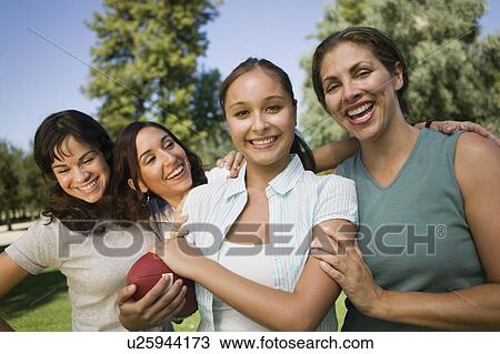 Four women playing football outdoors. View Large Photo Image Stock Image - Four women playing football outdoors.. Fotosearch