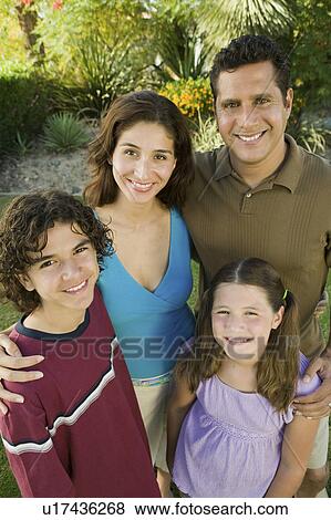 Stock Photo - Girl (7-9) with brother (13-15) and parents outdoors, elevated view portrait.. Fotosearch
